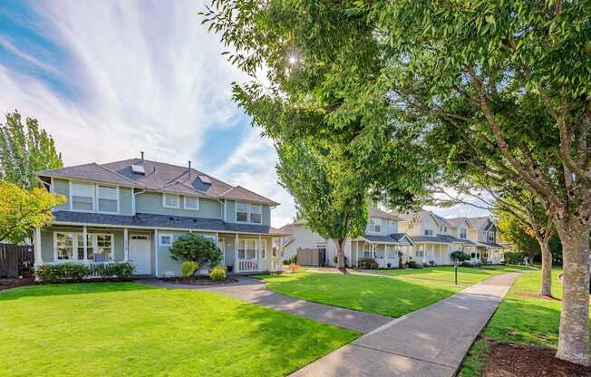 a sidewalk in front of a row of houses