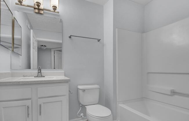 a bathroom with a sink toilet and bathtub