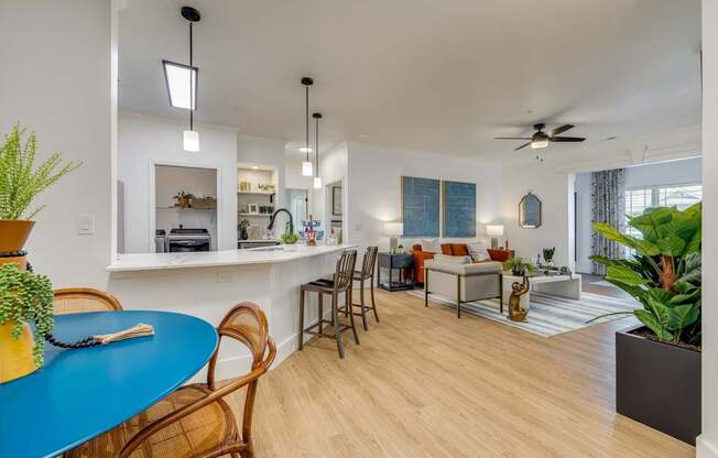 A living room with a blue table and chairs.