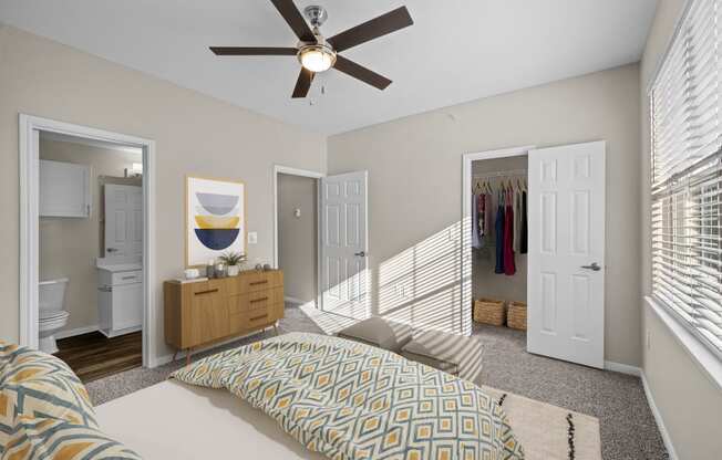 a bedroom with a large bed and a ceiling fan