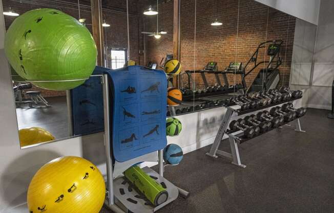 a fitness room with weights and other exercise equipment