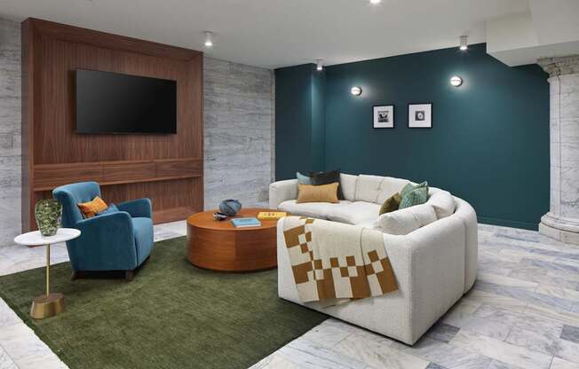 A living room with a white couch and a wooden entertainment unit.
