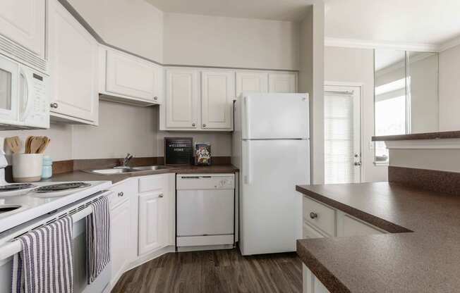 a kitchen with white appliances and white cabinets