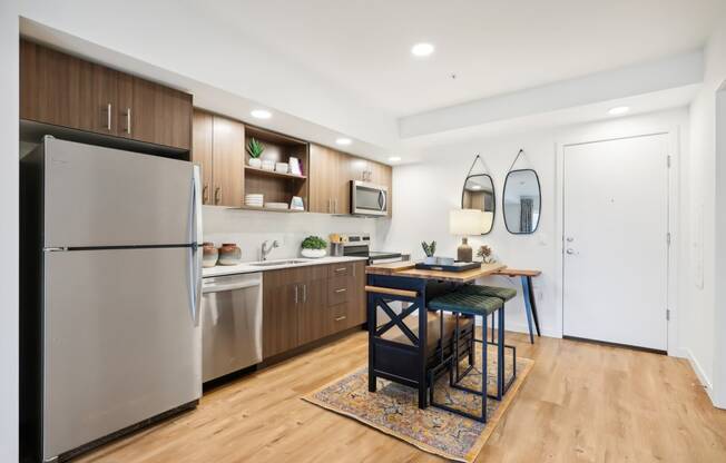 a kitchen with stainless steel appliances and a dining room table