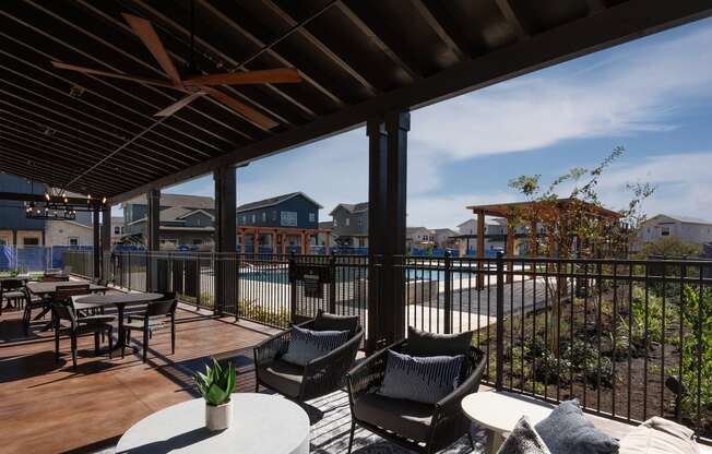 a patio with chairs and tables and a swimming pool