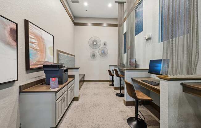 a long room with desks and computers in a cyber room