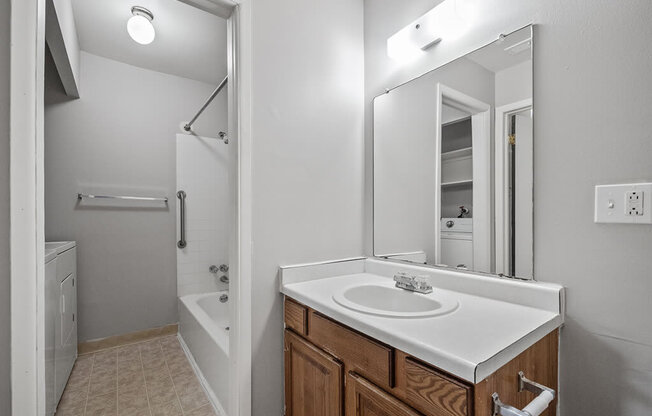 an empty bathroom with a sink and a mirror