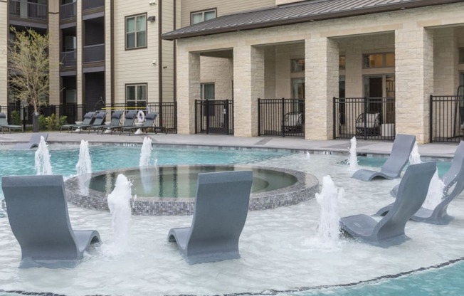 Resort-Style Pool with Grilling Area, Tanning Ledges, Cabanas & Hot Tub at The Bridge at McKinney