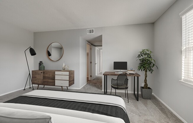Step into modern living at Crossings @ 501 Apartments. This stylish bedroom features sleek furnishings and a dedicated workspace, perfect for productivity and relaxation. Don't miss out on your ideal home—schedule a tour today!