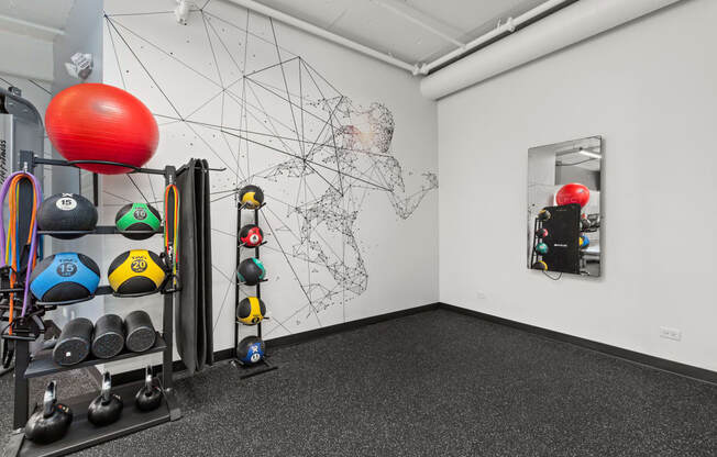 a fitness room with weights and a map on the wall