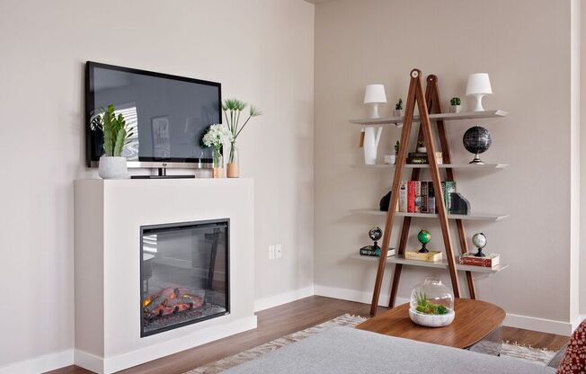 a living room with a fireplace and a television