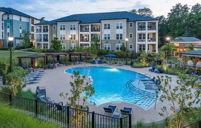 a large swimming pool in front of an apartment building