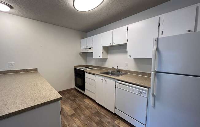 a kitchen with white cabinets and white appliances