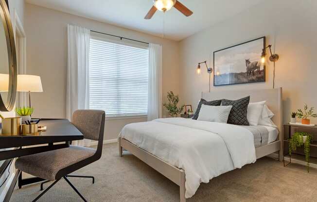 a bedroom with a bed and a desk and a window at Madison on the Meadow, Stafford, 77477