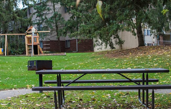 a park bench in front of a playground