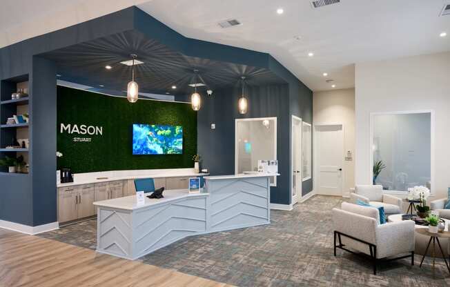 a lobby with a reception desk and a green wall with a tv