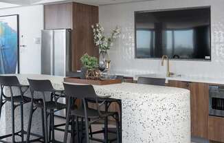 A kitchen with a table and chairs.