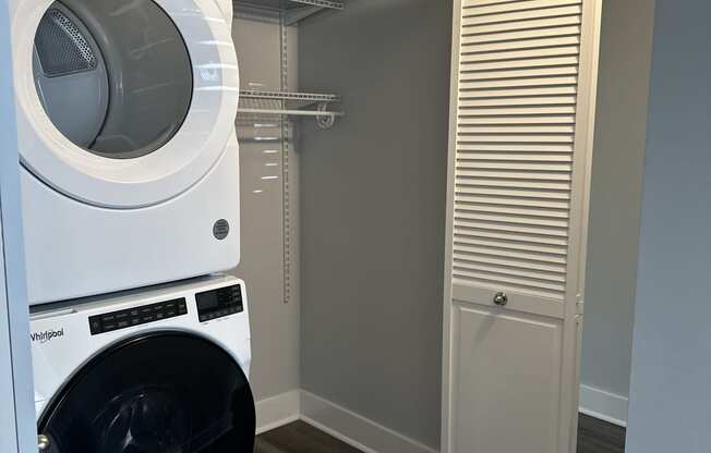 a washer and dryer in a laundry room with a closet