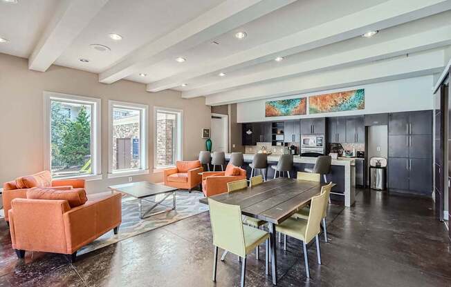 A modern kitchen and living room with a dining table and chairs.