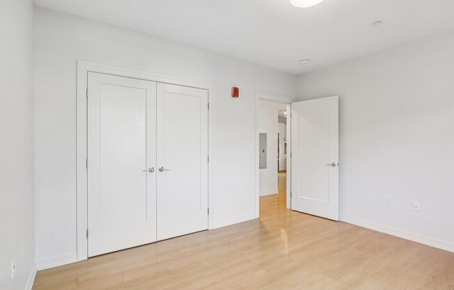 Spacious bedroom with wooden floor and closet at Park77 Apartments, Cambridge, MA