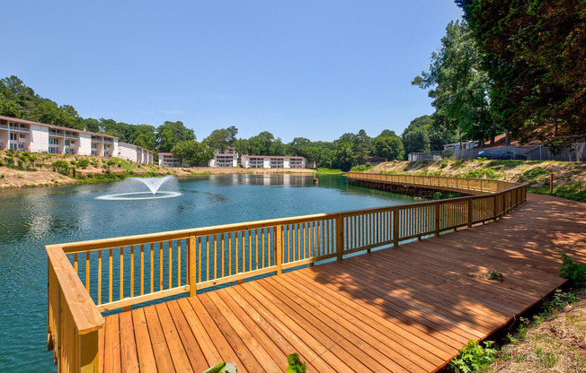 a deck overlooking a lake with a fountain