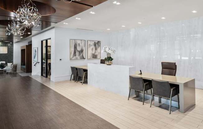 A modern office space with a long table and chairs.