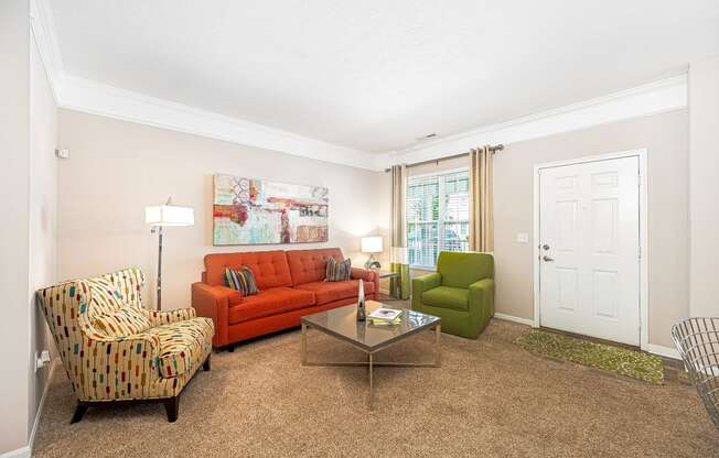 a living room with a couch and chairs and a table