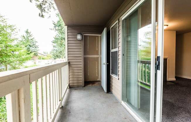 Tacoma Apartments - Sienna Apartments - Deck, Storage Room, Living Room, and Fireplace