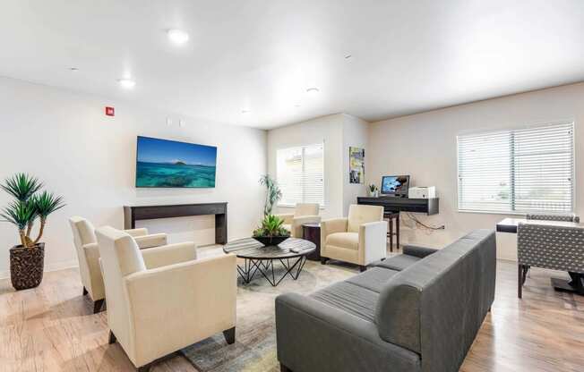 a living room with couches and chairs and a television at Parks Residential - Denver, Centennial Colorado