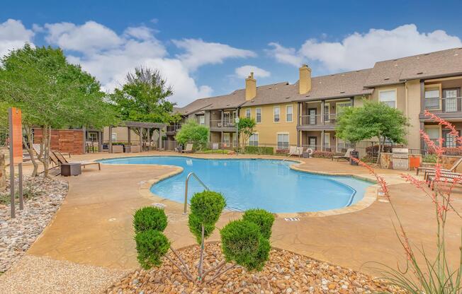 a house with a pool in front of a building
