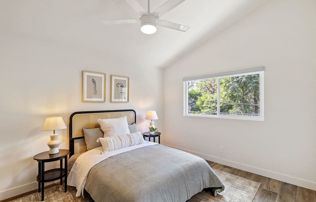 a bedroom with a bed and a ceiling fan