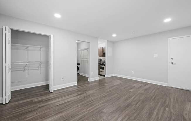 a renovated living room with white walls and wood flooring