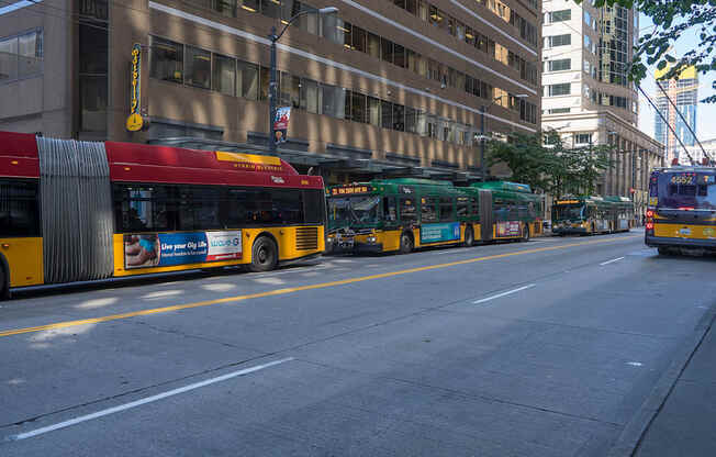 A red and yellow bus is parked on the side of a street.