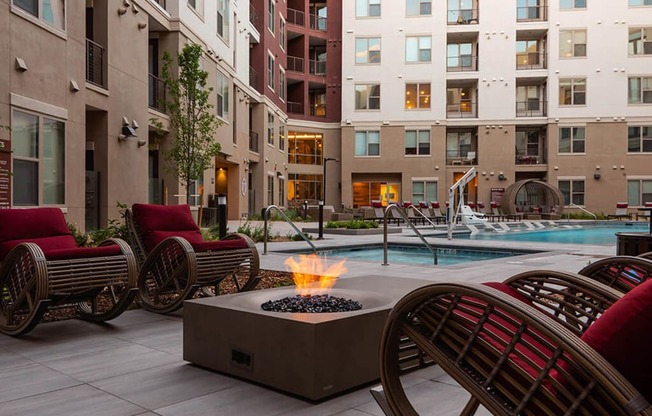 a patio with chairs and a fire pit