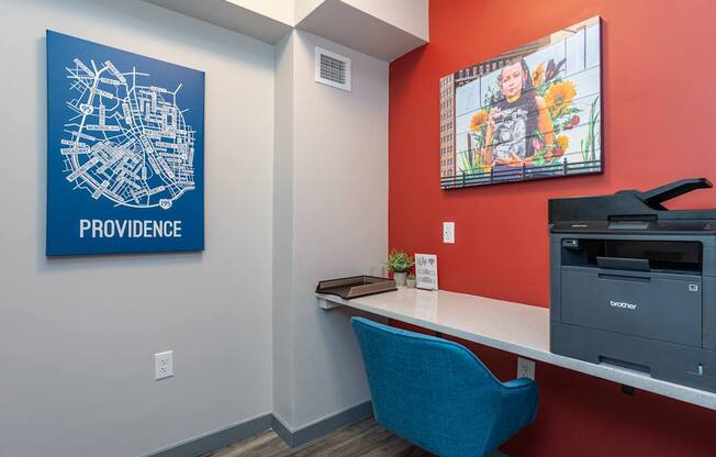 A blue chair sits in front of a Providence map on a wall.