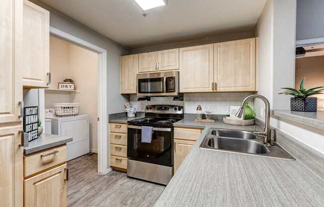 A kitchen with a stove, oven, and sink.