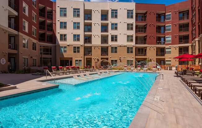 a swimming pool in front of an apartment building