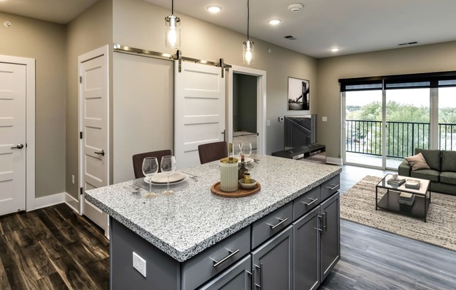 Large kitchens with white or black backsplashes at The Mill Apartments in Benson, NE