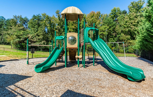 a playground with two slides at a park