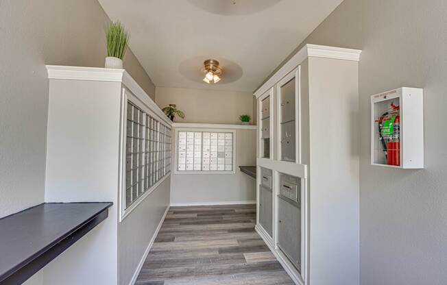 A long hallway with a cabinet and a window.