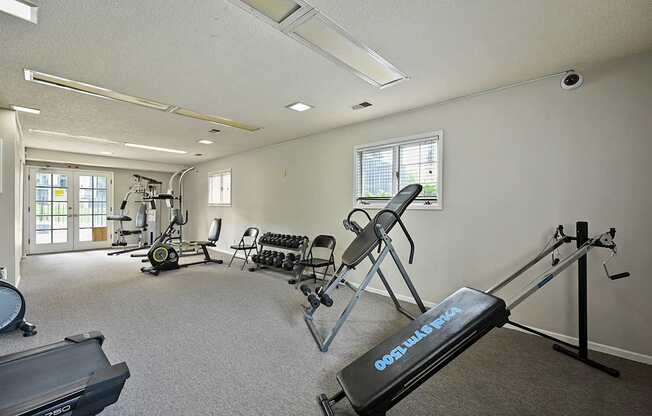 A gym with a treadmill that says Optima.