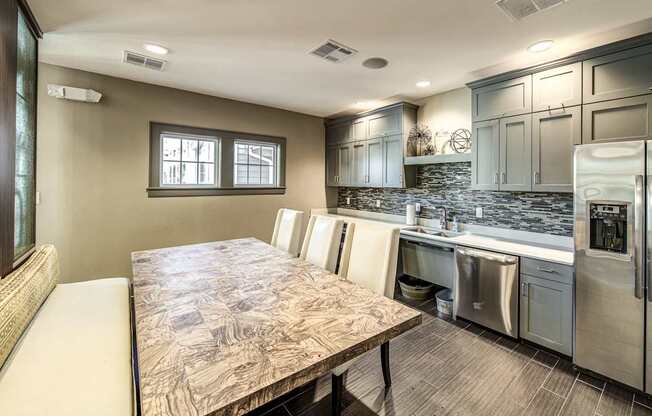 a kitchen with stainless steel appliances and a wooden table