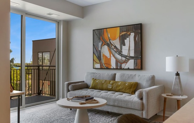 a living room with a couch a table and a window