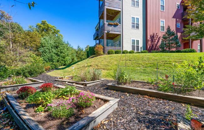 a garden in front of a house on a hill at River Mill Lofts & Skyloft, Asheville