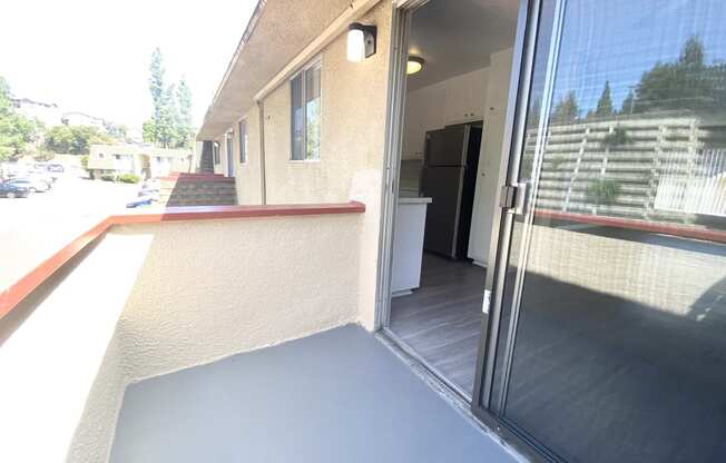 a view of the front porch of a building with a glass door