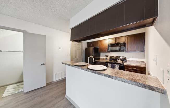 a kitchen with a counter top and a refrigerator