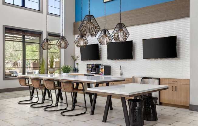 A modern dining room with a long table and chairs.