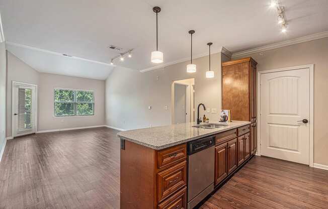 a kitchen and living room with hardwood floors