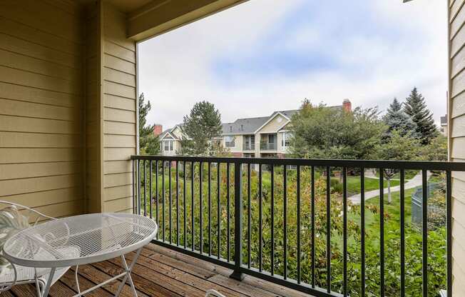 a patio with a table and chairs on a balcony