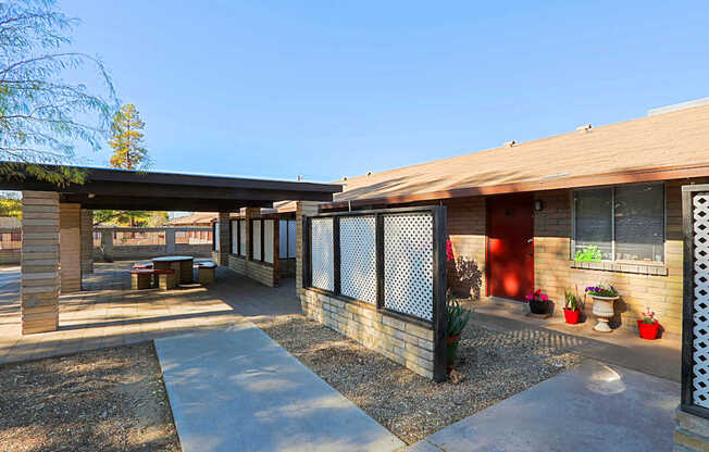 A modern building with a red door and a fence.